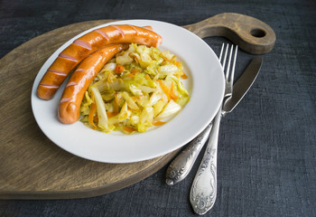 cabbage braised in white plate on black background