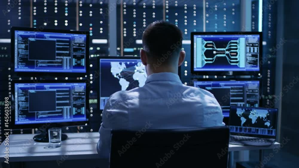 Leinwandbilder Technical Controller Working at His Workstation with Multiple Displays. Displays Show Various Technical Information. He's Alone in System Control Center. Shot on RED EPIC-W 8K Helium Cinema Camera.