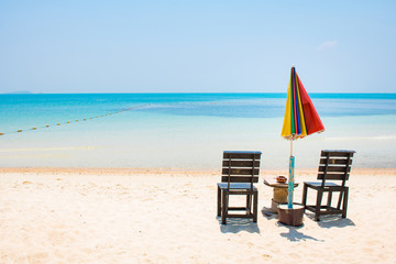 Two chairs with umbrela on white sand beach and blue sea in Samed Island, Thailand