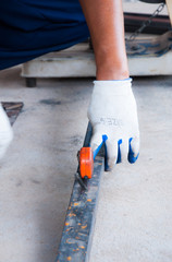 Worker hands use measuring tape measuring length of steel