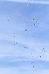 many paragliders on the sky