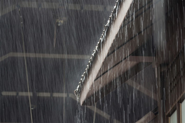 heavy rain on roof of wooden house, rainy season