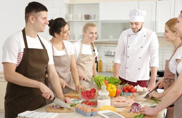 Male chef and group of people at cooking classes