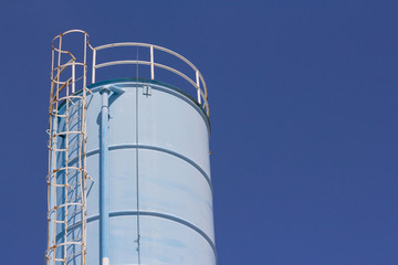 old steel silo against blue sky