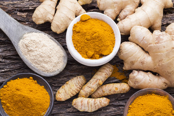 Powder and ginger root on curcuma powder and wood


 - Powered by Adobe