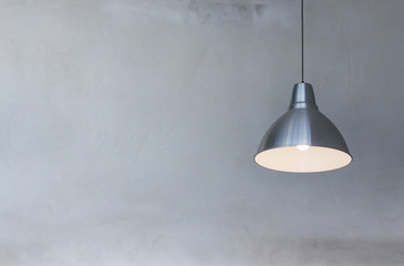 metal hanging lamp on concrete wall background