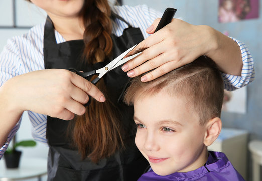 Cute little boy in hairdressing salon
