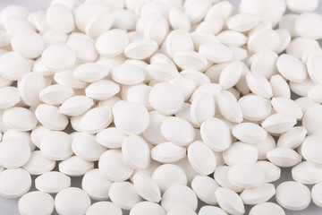 Fototapeta na wymiar White vitamin D pills on a white surface. Vitamins isolated on white background.