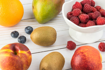 Fresh raspberries and fruits on a table.