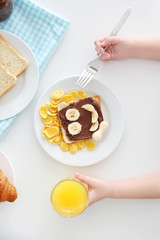 Cute child having breakfast at home