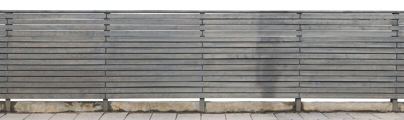 The rural long solid fence is made of horizontal wooden boards and painted with gray oil paint