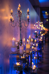Indoors wedding decoration in the evening with candles and fir branches - 145610849