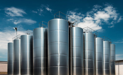 Huge stainless steel wine factory tanks shot outside at daylight