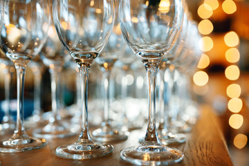 Close up picture of empty glasses on the wooden counter  in restaurant