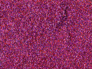 Abstract Christmas pink and purple glitter texture. Luxury magenta mixed color background with sparkling details. Cosmetics or holidays gift backdrop