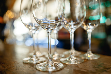 Close up picture of empty glasses on the wooden counter  in restaurant