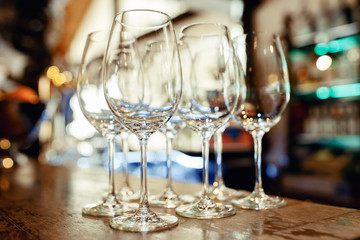Close up picture of empty glasses on the wooden counter  in restaurant