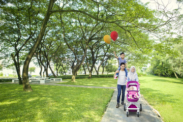 Muslim parents having fun with children in outdoor
