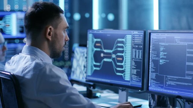  In the System Control Center Team of Technicians Monitor System Stability. Possible Air Traffic/ Power Plant/ Security Room Theme. Shot on RED EPIC-W 8K Helium Cinema Camera.