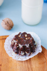 Chocolate cake on wooden board over bright background.