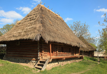 Traditional Ukrainian wooden house under thatched roof.Ukraine