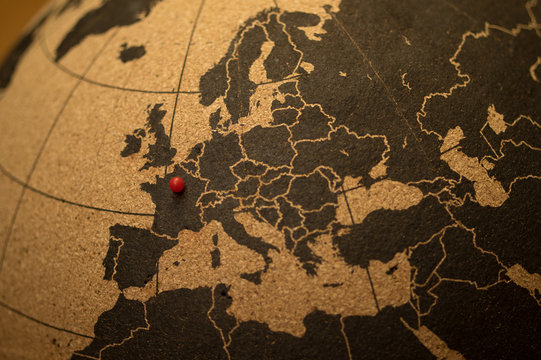 Red pin indicating Paris on cork globe