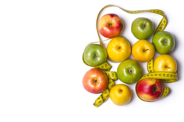 Concept of diet, apples with measuring tape isolated on white, top view.