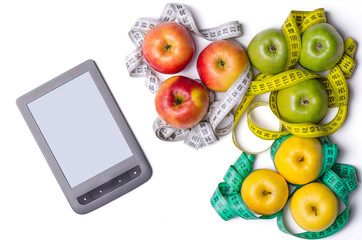 Concept of diet, tablet, apples with measuring tape isolated on white, top view.