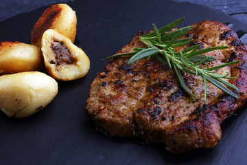 Grilled steaks, baked dumplings potatoes