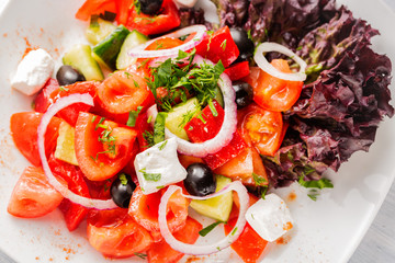 Fresh Greek salad with onion. Close up with selective focus