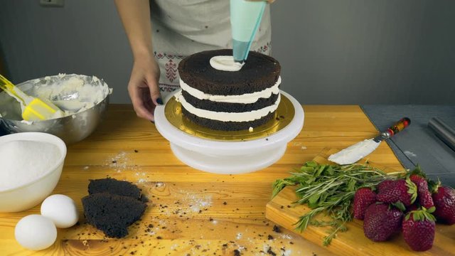 Pouring frosting on Cake. Making Chocolate Layer Cake. Series.