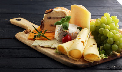 Cheese platter with different cheese and grapes