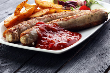 grilled sausages and potatoes and salad
