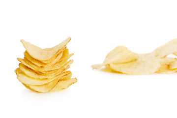 stack of crispy potato chips isolated on white background  close-up