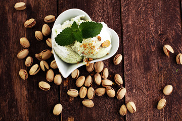 Fototapeta na wymiar Pistachio ice cream with chopped nuts and honey on a rustic background
