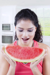 Young woman enjoys watermelon