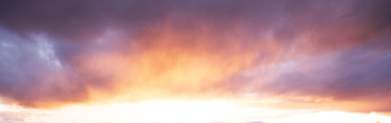 Dramatic, colorful cloudy sunset sky with clouds. Abstract background. Panorama