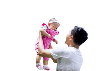 Young father holds his baby on studio