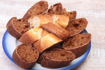 Sliced bread Ciabatta with plate on cutting board on wooden background