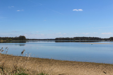 Pond with trees and blue sky. Czech landscape