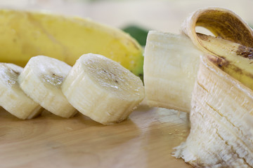 Banana ripe peel out and sliced on cutting board