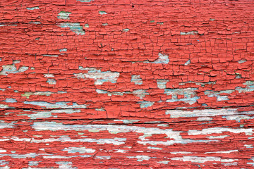 Old painted wall of wood, peeling red paint