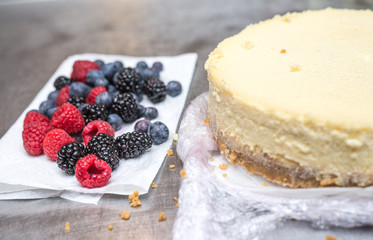 preparing a sweet cake in the kitchen, putting blueberries on it