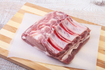 Raw pork chops, spices on cutting board. Ready for cooking.