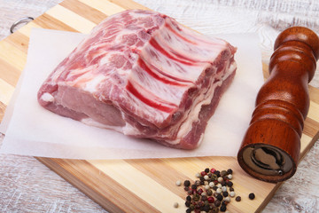 Raw pork chops and spice grinder on cutting board. Ready for cooking.