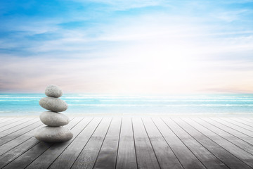 Stack of pebble stones at the beach on a wooden surface. Concept Zen, Spa, Summer, Beach, Sea, Relax.
