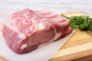 Raw pork chops, spices and basil on cutting board. Ready for cooking.