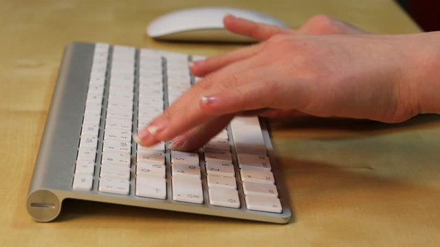 Fingerboard. Close up arms typing on the computer keyboard