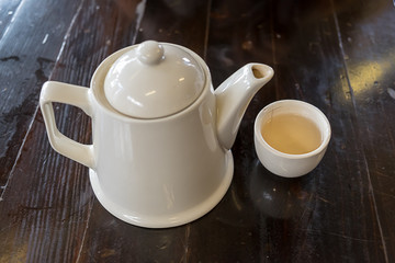 White teapot on the wood table