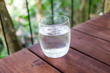 Glass of water on a wooden table